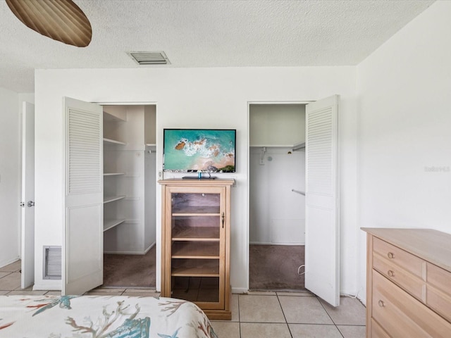 4567 Great Lakes Dr S, Clearwater, FL 33762 - bedroom with light tile patterned floors, a textured ceiling, and a closet
