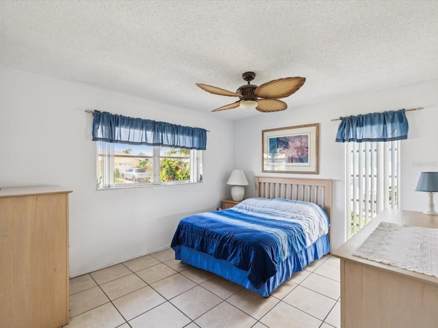 4567 Great Lakes Dr S, Clearwater, FL 33762 - bedroom featuring light tile patterned floors, a textured ceiling, and a ceiling fan