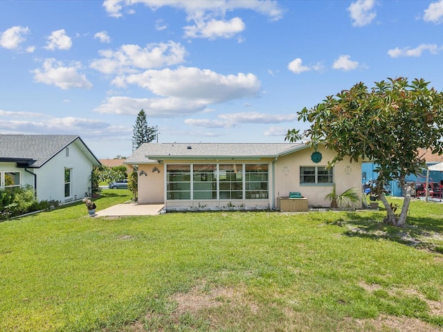 4567 Great Lakes Dr S, Clearwater, FL 33762 - rear view of house with stucco siding, a yard, and a patio area