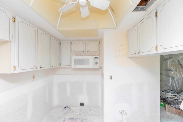 4754 Marine Pkwy Unit 103, New Port Richey, FL 34652 - kitchen featuring white microwave, a ceiling fan, and light countertops