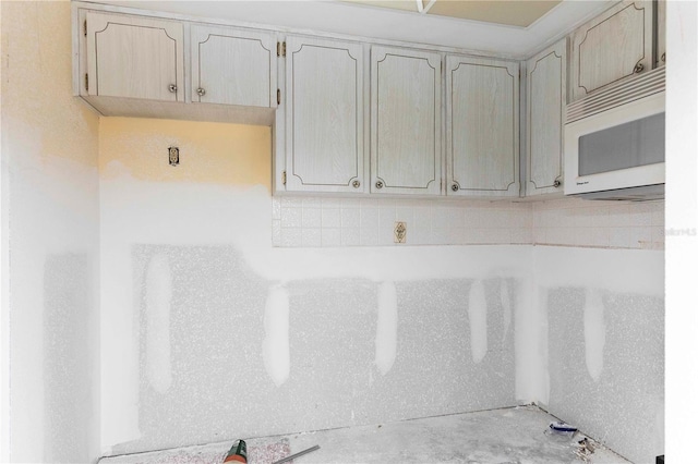 4754 Marine Pkwy Unit 103, New Port Richey, FL 34652 - detailed view of white microwave and backsplash