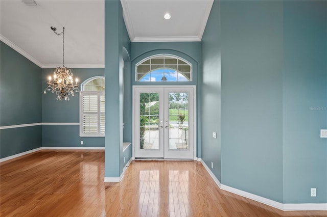 4351 Mallard Lake Dr, Spring Hill, FL 34609 - foyer entrance featuring ornamental molding, french doors, wood finished floors, and a chandelier