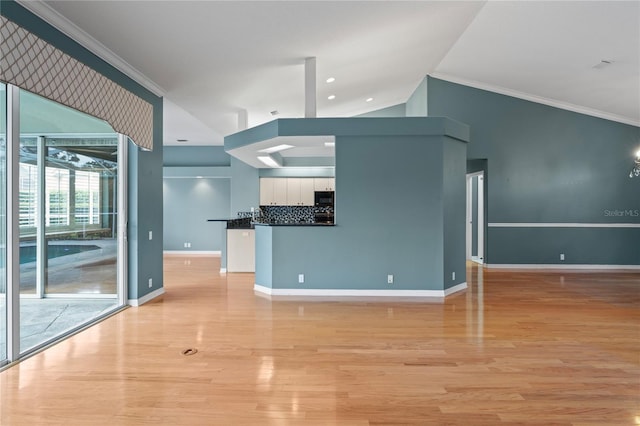 4351 Mallard Lake Dr, Spring Hill, FL 34609 - unfurnished living room featuring light wood-style floors, ornamental molding, vaulted ceiling, and recessed lighting