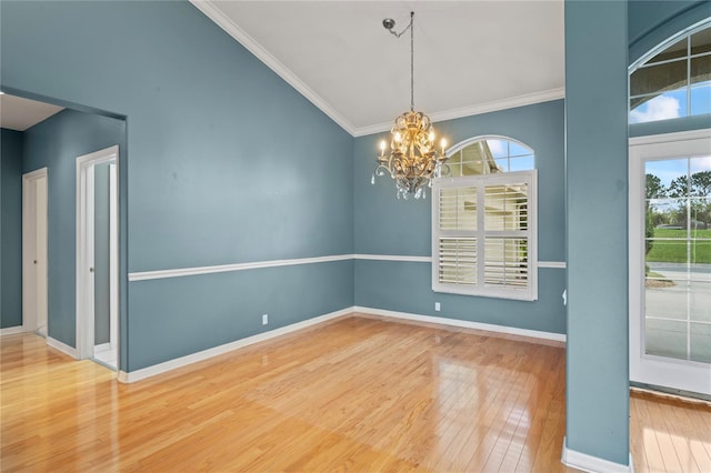 4351 Mallard Lake Dr, Spring Hill, FL 34609 - empty room featuring wood finished floors, healthy amount of natural light, a chandelier, and crown molding