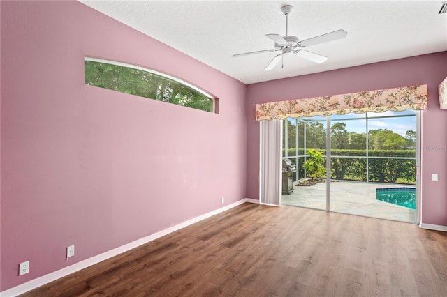 4351 Mallard Lake Dr, Spring Hill, FL 34609 - spare room with wood finished floors, ceiling fan, and a textured ceiling