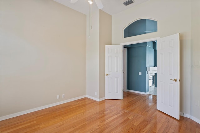 4351 Mallard Lake Dr, Spring Hill, FL 34609 - unfurnished room with light wood finished floors, a ceiling fan, and a towering ceiling