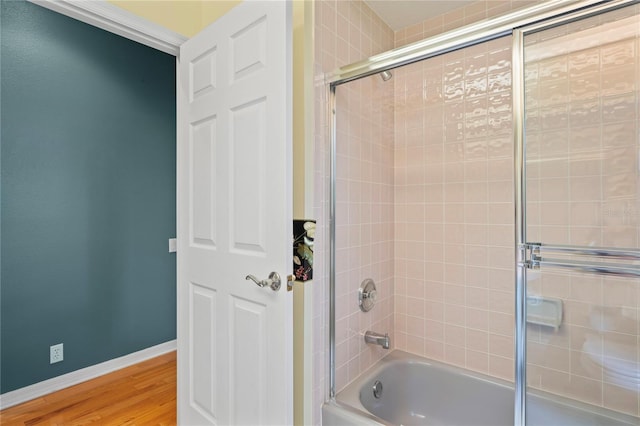 4351 Mallard Lake Dr, Spring Hill, FL 34609 - bathroom featuring shower / bath combination with glass door and wood finished floors