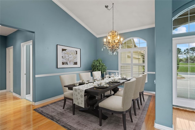 4351 Mallard Lake Dr, Spring Hill, FL 34609 - dining room featuring wood finished floors, a chandelier, plenty of natural light, and ornamental molding