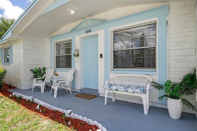 6144 Glenwood Dr, New Port Richey, FL 34653 - view of exterior entry featuring covered porch and concrete block siding