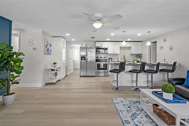 6144 Glenwood Dr, New Port Richey, FL 34653 - living area with ceiling fan, light wood-type flooring, and recessed lighting