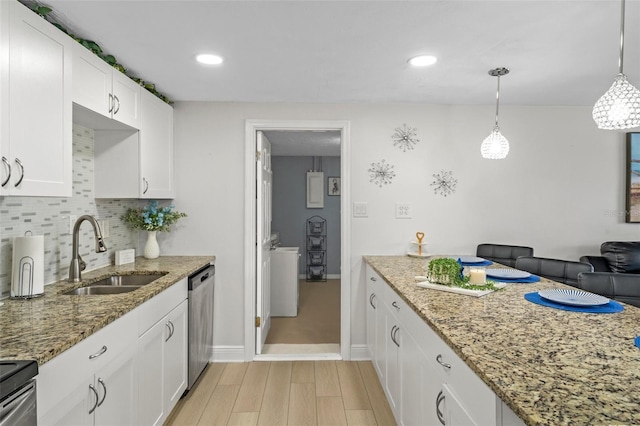 6144 Glenwood Dr, New Port Richey, FL 34653 - kitchen with light wood finished floors, white cabinetry, backsplash, light stone countertops, and stainless steel appliances