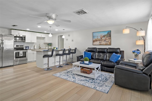 6144 Glenwood Dr, New Port Richey, FL 34653 - living room featuring ceiling fan, light wood-style floors, and recessed lighting