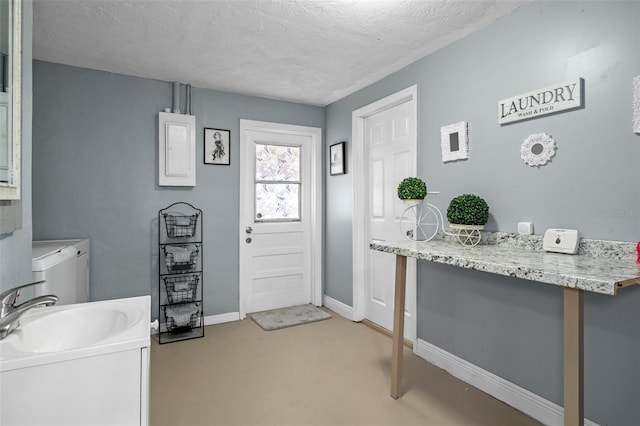 6144 Glenwood Dr, New Port Richey, FL 34653 - foyer featuring independent washer and dryer, a textured ceiling, and light colored carpet