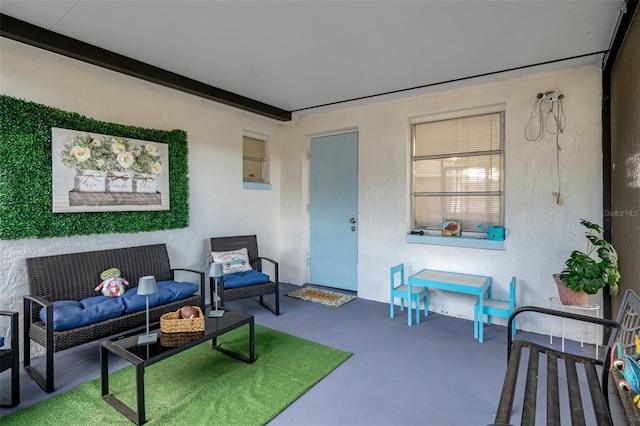 6144 Glenwood Dr, New Port Richey, FL 34653 - living area with concrete flooring and a textured wall