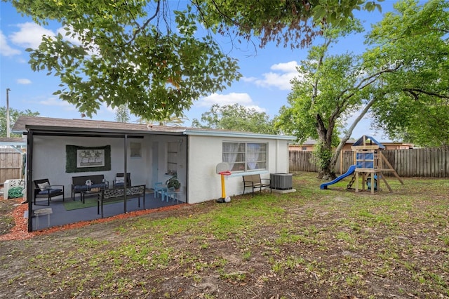 6144 Glenwood Dr, New Port Richey, FL 34653 - rear view of property with a fenced backyard, stucco siding, a patio, and a playground