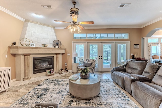 11510 Lakeview Dr, New Port Richey, FL 34654 - living room featuring crown molding, arched walkways, ceiling fan, a high end fireplace, and ornate columns