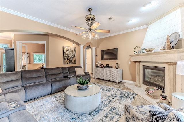 11510 Lakeview Dr, New Port Richey, FL 34654 - living area with ceiling fan, arched walkways, ornamental molding, a premium fireplace, and decorative columns