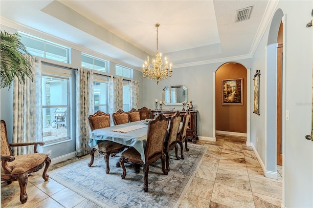 11510 Lakeview Dr, New Port Richey, FL 34654 - dining room with arched walkways, a raised ceiling, a chandelier, and ornamental molding