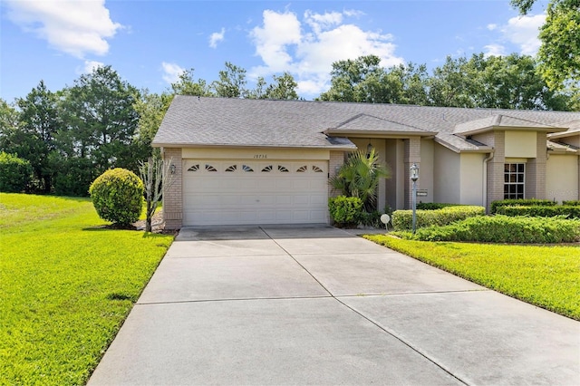 18736 Bent Pine Dr, Hudson, FL 34667 - view of front of home featuring brick siding, driveway, a garage, a front lawn, and a shingled roof