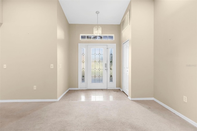 18736 Bent Pine Dr, Hudson, FL 34667 - carpeted foyer entrance featuring a chandelier and a high ceiling