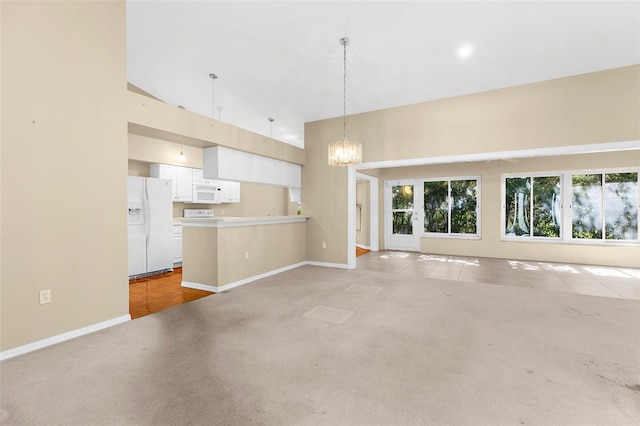 18736 Bent Pine Dr, Hudson, FL 34667 - unfurnished living room featuring a chandelier, high vaulted ceiling, and light colored carpet