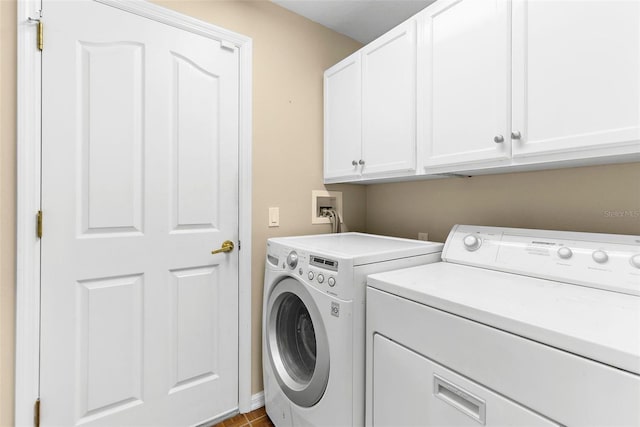 18736 Bent Pine Dr, Hudson, FL 34667 - laundry room featuring cabinet space and independent washer and dryer