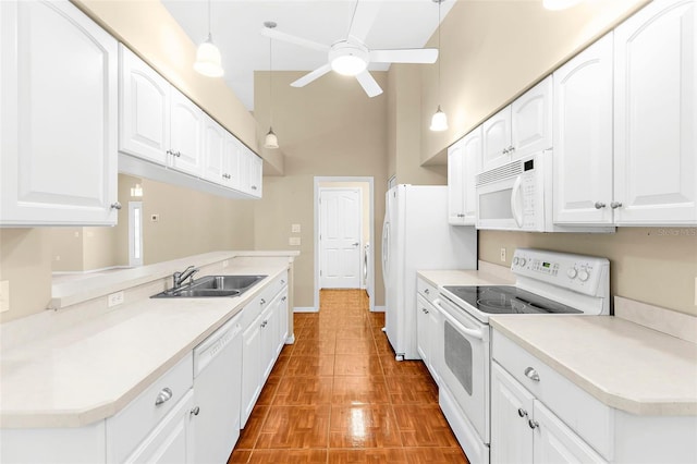 18736 Bent Pine Dr, Hudson, FL 34667 - kitchen with white appliances, ceiling fan, a towering ceiling, white cabinets, and light countertops