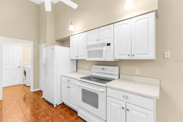18736 Bent Pine Dr, Hudson, FL 34667 - kitchen with white appliances, white cabinets, washer and dryer, and light countertops