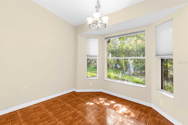 18736 Bent Pine Dr, Hudson, FL 34667 - spare room with a chandelier and baseboards