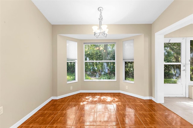 18736 Bent Pine Dr, Hudson, FL 34667 - tiled spare room with a chandelier and baseboards