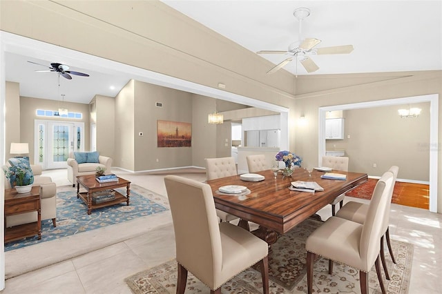 18736 Bent Pine Dr, Hudson, FL 34667 - dining area featuring a ceiling fan, a chandelier, light tile patterned flooring, and vaulted ceiling