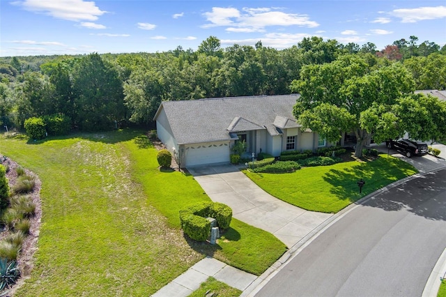 18736 Bent Pine Dr, Hudson, FL 34667 - view of front facade with driveway, a garage, a front yard, stucco siding, and a wooded view
