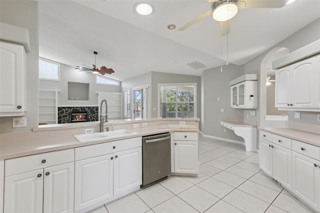 4052 Marine Pkwy, New Port Richey, FL 34652 - kitchen with stainless steel dishwasher, ceiling fan, light tile patterned floors, lofted ceiling, and light countertops
