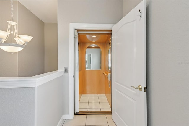 4052 Marine Pkwy, New Port Richey, FL 34652 - hall with light tile patterned floors and a chandelier