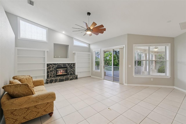 4052 Marine Pkwy, New Port Richey, FL 34652 - living room featuring built in features, a stone fireplace, light tile patterned flooring, ceiling fan, and high vaulted ceiling