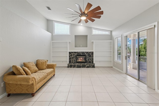 4052 Marine Pkwy, New Port Richey, FL 34652 - living area featuring high vaulted ceiling, a ceiling fan, built in shelves, healthy amount of natural light, and a stone fireplace