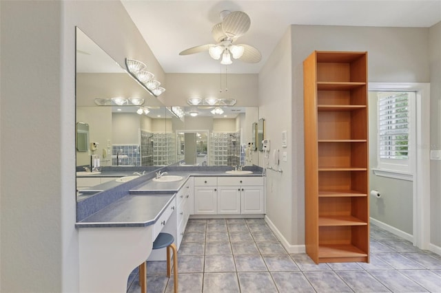 4052 Marine Pkwy, New Port Richey, FL 34652 - bathroom with ceiling fan, vanity, a tile shower, and tile patterned flooring