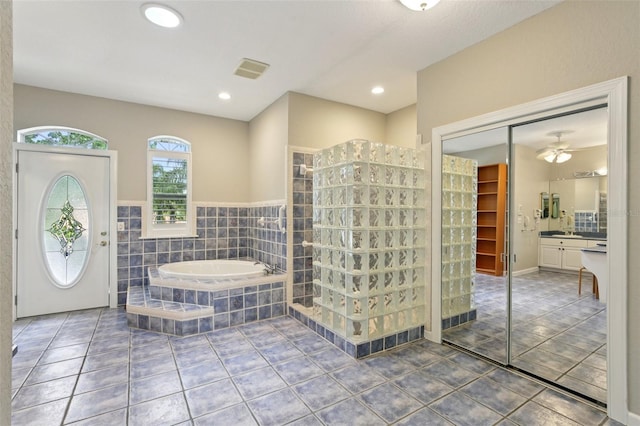 4052 Marine Pkwy, New Port Richey, FL 34652 - full bathroom with tile patterned flooring, a bath, vanity, walk in shower, and recessed lighting
