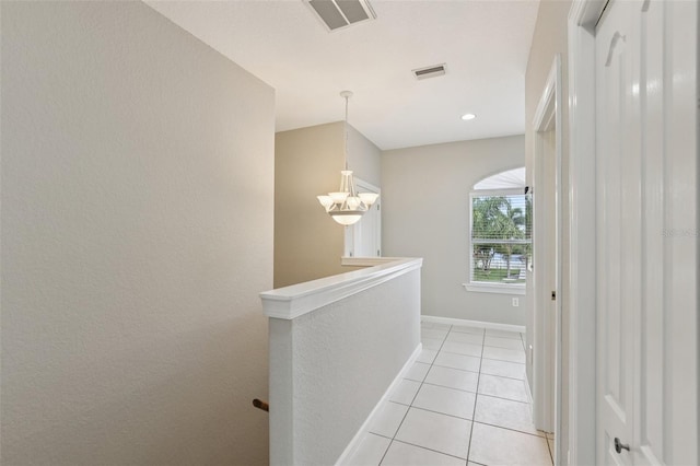 4052 Marine Pkwy, New Port Richey, FL 34652 - hallway with an upstairs landing, light tile patterned floors, and a chandelier