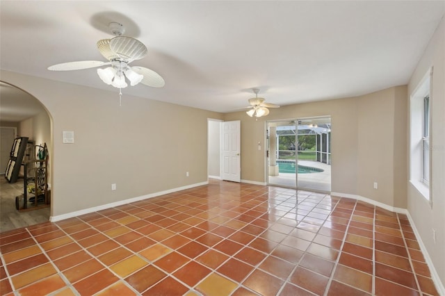 4052 Marine Pkwy, New Port Richey, FL 34652 - spare room featuring ceiling fan, tile patterned flooring, and arched walkways