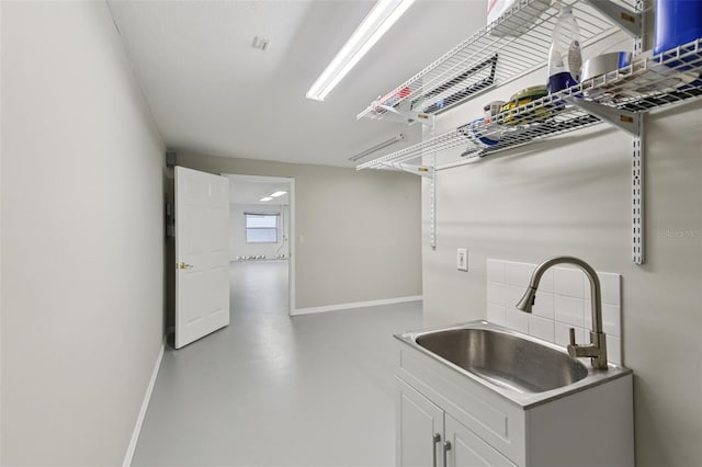4052 Marine Pkwy, New Port Richey, FL 34652 - kitchen featuring tasteful backsplash, concrete floors, and white cabinets