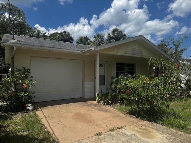 6826 Driftwood Dr, Hudson, FL 34667 - view of front facade featuring an attached garage, concrete driveway, and stucco siding