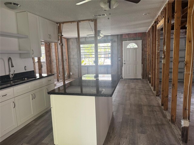 6826 Driftwood Dr, Hudson, FL 34667 - kitchen featuring a ceiling fan, open shelves, dark wood finished floors, white cabinets, and a textured ceiling