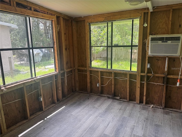 6826 Driftwood Dr, Hudson, FL 34667 - empty room featuring healthy amount of natural light, wood finished floors, and a wall unit AC