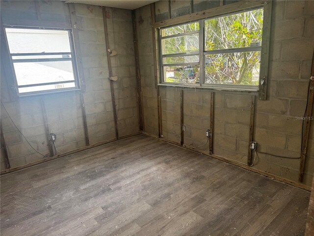 6826 Driftwood Dr, Hudson, FL 34667 - spare room featuring wood finished floors, healthy amount of natural light, and concrete block wall