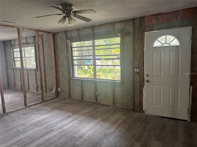 6826 Driftwood Dr, Hudson, FL 34667 - foyer entrance with a ceiling fan, wood finished floors, a textured ceiling, and concrete block wall