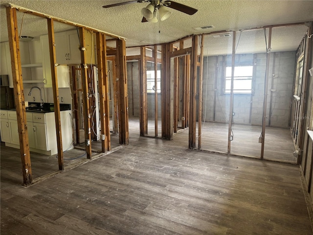 6826 Driftwood Dr, Hudson, FL 34667 - miscellaneous room featuring ceiling fan, dark wood finished floors, and a textured ceiling