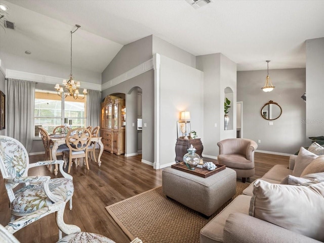 12060 Sapphire Dr, Spring Hill, FL 34609 - living room with lofted ceiling, arched walkways, a chandelier, and dark wood-style flooring
