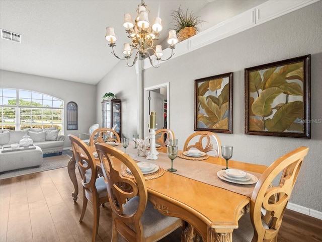 12060 Sapphire Dr, Spring Hill, FL 34609 - dining area with wood finished floors, a chandelier, and high vaulted ceiling