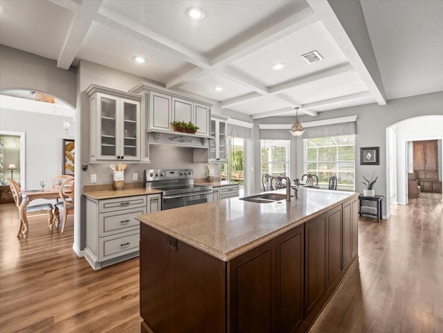 12060 Sapphire Dr, Spring Hill, FL 34609 - kitchen with electric range, arched walkways, coffered ceiling, dark wood-style floors, and glass insert cabinets